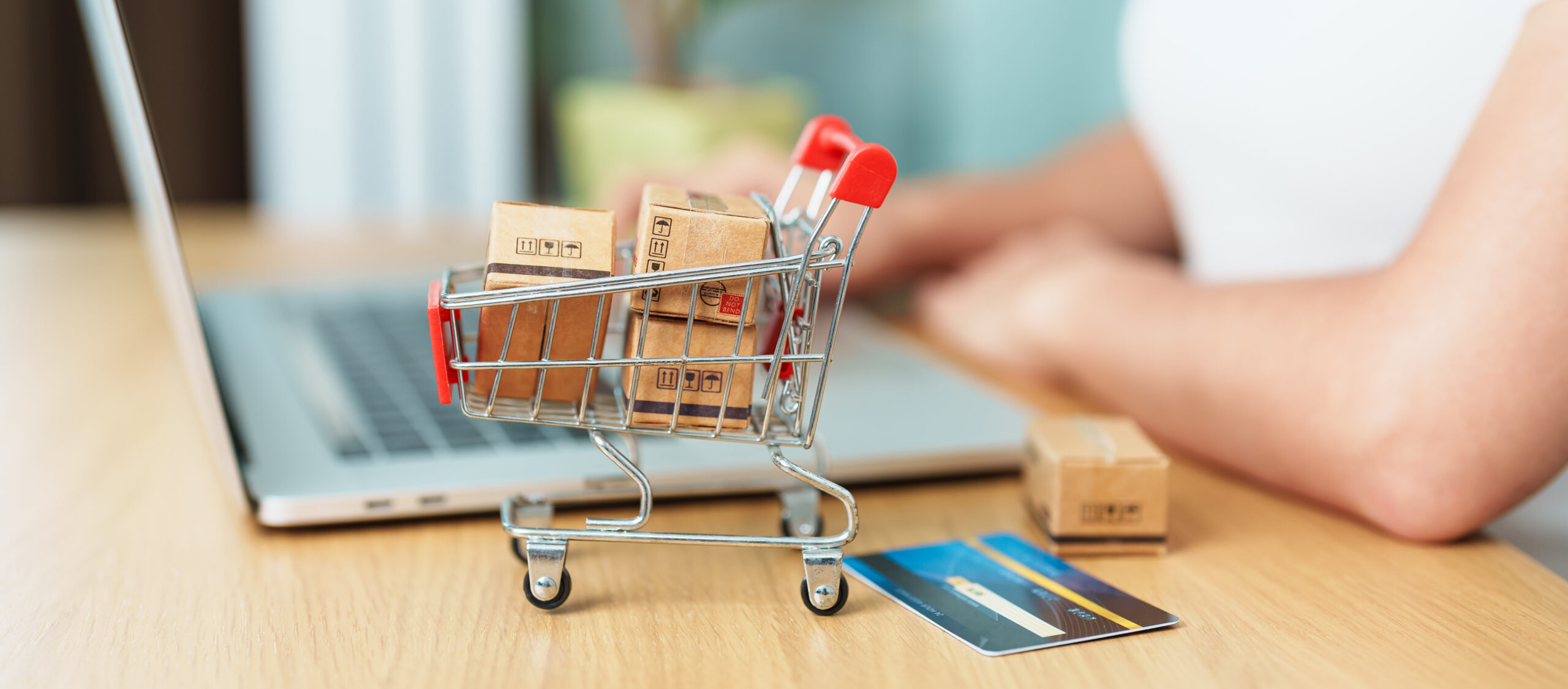 woman hand holding credit card and using laptop with mobile phon